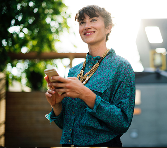 woman looking happy and inspired with smartphone