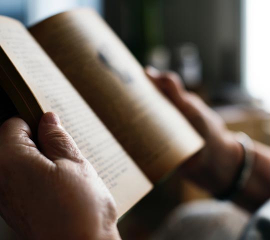 older gentleman holding book